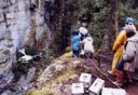 Andy Laszlo strapped on a plank of wood and dangling from the edge of the canyon